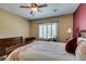 This bedroom features a ceiling fan, shuttered windows, and comfortable bedding, creating a relaxing retreat at , Henderson, NV 89044