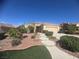 Inviting single-story home with desert landscaping, walkway, and attached two car garage at , Henderson, NV 89044