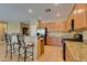 Well-lit kitchen features stainless steel appliances, granite countertops, a breakfast bar and tile flooring at , Henderson, NV 89044