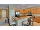 Kitchen with stainless steel refrigerator, granite countertops, breakfast bar, and tile floors at , Henderson, NV 89044