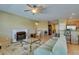 Comfortable living room with a fireplace, ceiling fan, and an open view to the kitchen at , Henderson, NV 89044