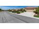 A wide street view showcases the well-manicured lawns and diverse landscaping of the neighborhood homes at , Henderson, NV 89044