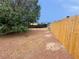 An expansive backyard featuring a wooden fence and ample room, perfect for outdoor activities and relaxation at 1004 Stone River Dr, North Las Vegas, NV 89030