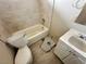 Bathroom with tub, toilet, and vanity needs renovations, and repair work at 1004 Stone River Dr, North Las Vegas, NV 89030