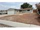 Classic single-story home featuring an attached garage and drought-resistant front yard at 1004 Stone River Dr, North Las Vegas, NV 89030