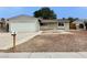 Cozy home featuring a two-car garage, complemented by a tidy, low-maintenance front yard landscape at 1004 Stone River Dr, North Las Vegas, NV 89030