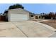 Home featuring a spacious two-car garage and a low-maintenance front yard at 1004 Stone River Dr, North Las Vegas, NV 89030