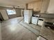Open-concept kitchen area adjacent to the living space with basic appliances at 1004 Stone River Dr, North Las Vegas, NV 89030