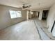 Bright and airy living room with tile flooring, ceiling fan, and ample natural light at 1004 Stone River Dr, North Las Vegas, NV 89030
