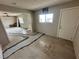 Living room featuring damaged flooring and natural light, showcasing the space's potential at 1004 Stone River Dr, North Las Vegas, NV 89030