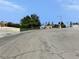 Wide street view displaying a quiet residential area lined with homes and lush greenery at 1004 Stone River Dr, North Las Vegas, NV 89030