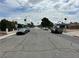 Street view showing well-maintained street with mature trees and a clear sky at 1004 Stone River Dr, North Las Vegas, NV 89030