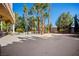 Spacious backyard patio area with tropical landscaping and a water feature at 1008 Trophy Hills Dr, Las Vegas, NV 89134