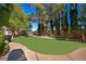 Beautiful backyard with a lush lawn and a variety of mature trees and plants at 1008 Trophy Hills Dr, Las Vegas, NV 89134