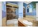 Bathroom featuring a marble countertop vanity and shower over tub with glass doors at 1008 Trophy Hills Dr, Las Vegas, NV 89134