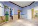 Themed bedroom featuring beach mural, two large arched windows, and mirrored closet at 1008 Trophy Hills Dr, Las Vegas, NV 89134