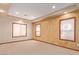 Bright bedroom with carpet flooring, three windows, and decorative tan wall paint at 1008 Trophy Hills Dr, Las Vegas, NV 89134
