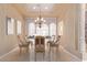 Formal dining room with elegant chandelier, arched windows, and natural light at 1008 Trophy Hills Dr, Las Vegas, NV 89134
