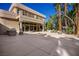 The exterior of the home features a large patio area and beautiful landscaping at 1008 Trophy Hills Dr, Las Vegas, NV 89134