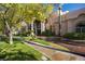 Elegant home exterior featuring lush landscaping, mature trees, and a circular driveway at 1008 Trophy Hills Dr, Las Vegas, NV 89134
