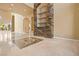 Elegant foyer with decorative tile and a statement stone fireplace at 1008 Trophy Hills Dr, Las Vegas, NV 89134