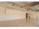 Spacious two car garage with painted floor, storage cabinets, and water heater at 1008 Trophy Hills Dr, Las Vegas, NV 89134