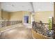Upstairs hallway with carpet flooring and wrought iron railings providing an open feel at 1008 Trophy Hills Dr, Las Vegas, NV 89134