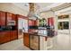 Gourmet kitchen featuring stainless steel appliances, island cooktop, and wine fridge at 1008 Trophy Hills Dr, Las Vegas, NV 89134
