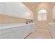 Bright laundry room features ample storage and a modern washer and dryer set at 1008 Trophy Hills Dr, Las Vegas, NV 89134