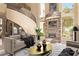 Inviting living room featuring a stone fireplace, spiral staircase, and neutral decor at 1008 Trophy Hills Dr, Las Vegas, NV 89134