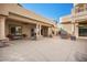 Expansive covered patio with stone columns and a built-in outdoor grill area at 1008 Trophy Hills Dr, Las Vegas, NV 89134