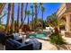 Stunning pool and rock waterfall surrounded by lush tropical landscaping and seating areas at 1008 Trophy Hills Dr, Las Vegas, NV 89134
