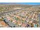 Aerial view featuring a residential neighborhood with palm trees, sidewalks, and desert landscaping at 10113 Walhalla Plateau Ct, Las Vegas, NV 89148