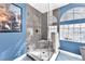 Stylish bathroom showcasing a walk-in shower with gray tiling and a glass block window at 10113 Walhalla Plateau Ct, Las Vegas, NV 89148