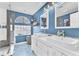 Charming bathroom with double sinks, decorative mirrors, stylish lighting, and a tiled shower at 10113 Walhalla Plateau Ct, Las Vegas, NV 89148