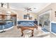 Bright game room with pool table, bar seating, and sliding glass doors to the backyard at 10113 Walhalla Plateau Ct, Las Vegas, NV 89148