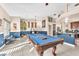 Open game room with a pool table and bar seating near the kitchen at 10113 Walhalla Plateau Ct, Las Vegas, NV 89148