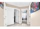 Hallway showing doors to rooms, including a bedroom with a ceiling fan and blinds at 10113 Walhalla Plateau Ct, Las Vegas, NV 89148