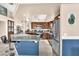 Bright kitchen featuring modern appliances, light countertops, stainless appliances, tile flooring and bar seating at 10113 Walhalla Plateau Ct, Las Vegas, NV 89148