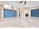 Open-concept living room with tile floors, fireplace, and blue accent wall at 10113 Walhalla Plateau Ct, Las Vegas, NV 89148