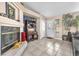Open-concept living room boasting a fireplace, tiled floors, a decorative bar, and neutral decor at 10113 Walhalla Plateau Ct, Las Vegas, NV 89148
