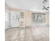 Bright living room with tile floors, front door access, and window views at 10113 Walhalla Plateau Ct, Las Vegas, NV 89148