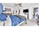 A main bedroom with a flat screen TV and an ensuite bathroom at 10113 Walhalla Plateau Ct, Las Vegas, NV 89148