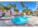 Private backyard oasis with a sparkling pool, hot tub, and lush landscaping at 10113 Walhalla Plateau Ct, Las Vegas, NV 89148