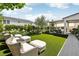 Beautiful backyard showcasing the plush artificial grass, manicured landscaping, and stylish lounge seating and pergola at 10196 Sequoia Glen Ave, Las Vegas, NV 89166