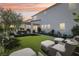 Luxurious backyard with manicured lawn, patio seating, covered outdoor kitchen perfect for relaxing or entertaining at 10196 Sequoia Glen Ave, Las Vegas, NV 89166