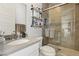 Modern bathroom includes gray tile, glass shower door, and floating shelves at 10196 Sequoia Glen Ave, Las Vegas, NV 89166