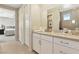 Bright bathroom featuring a vanity with white cabinets, neutral countertops, and an open doorway to a bedroom at 10196 Sequoia Glen Ave, Las Vegas, NV 89166