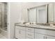 Bright bathroom with a double sink vanity, and a shower/tub combo with a glass enclosure for a clean and modern design at 10196 Sequoia Glen Ave, Las Vegas, NV 89166