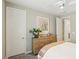 Cozy bedroom featuring light wood dresser with decor and a neutral color scheme, creating a warm and inviting atmosphere at 10196 Sequoia Glen Ave, Las Vegas, NV 89166